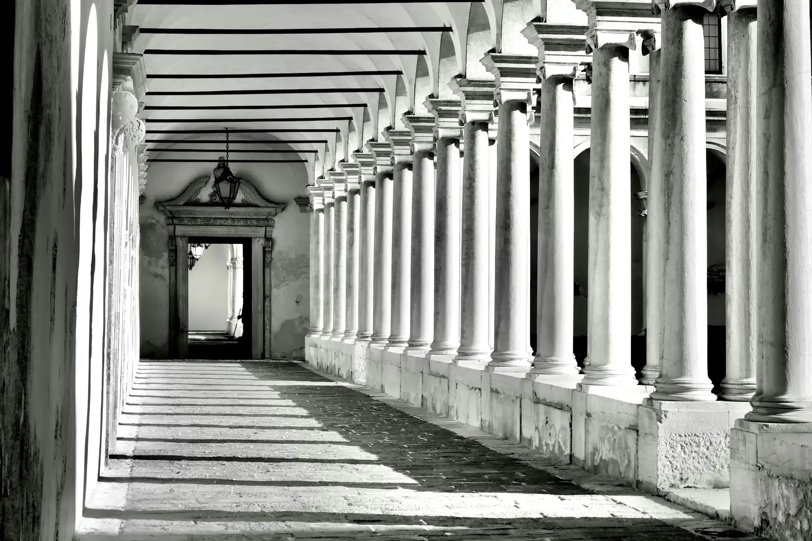 A vaulted colonnade receding into the distance, one identical column after another - the uniformity that gives a manufactured footprint away on inspection